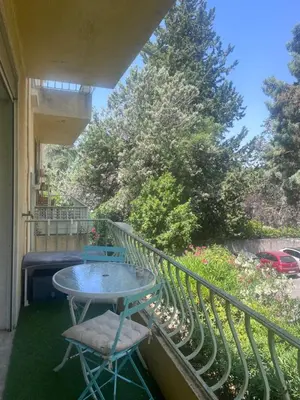 a table and two chairs on a balcony at Aix centre - Appartement Cosy avec Terrasse et Clim in Aix-en-Provence