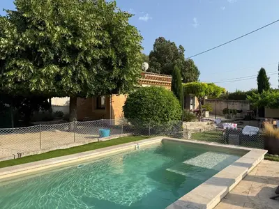 a swimming pool in the backyard of a house at Cabanon Lourmarin in Lourmarin