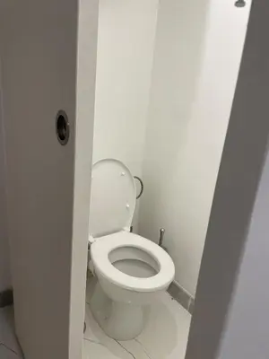 a bathroom with a white toilet in a stall at Plaisir de vacances in Aix-en-Provence