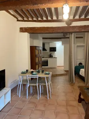 a kitchen and living room with a table and chairs at Plaisir de vacances in Aix-en-Provence