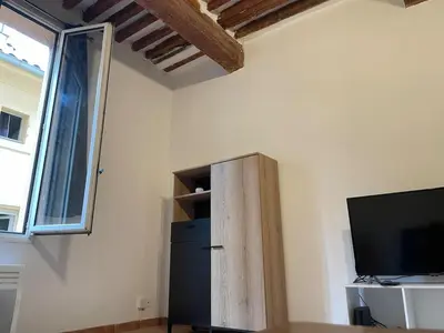 a small refrigerator in a room with a tv at Plaisir de vacances in Aix-en-Provence