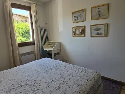 a bedroom with a bed and a desk and a window at 3 Bedroom House Terrace Park & Free Parking in Aix-en-Provence