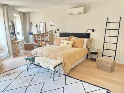a bedroom with a large bed with a ladder at Saint-Jean-des-Cèdres in Aix-en-Provence