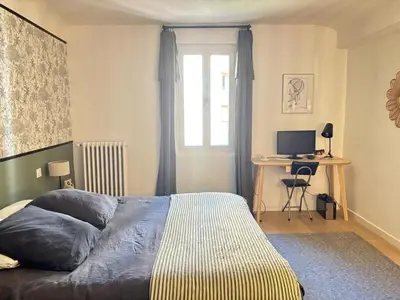 a bedroom with a bed and a desk with a computer at Saint-Jean-des-Cèdres in Aix-en-Provence