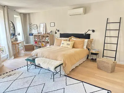 a bedroom with a large bed with a ladder at Saint-Jean-des-Cèdres in Aix-en-Provence