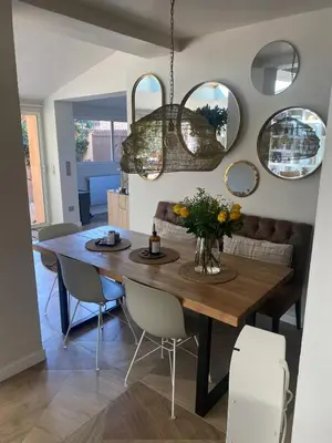 a dining room with a wooden table and mirrors at Saint-Jean-des-Cèdres in Aix-en-Provence