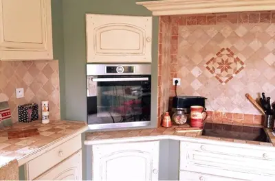 a kitchen with white cabinets and an oven at Belle bastide provençale in Noves