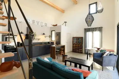 a living room with a couch and a table at Loft en Provence - Terrasse-Climatisation-Proche Golf et Luberon in Vernègues