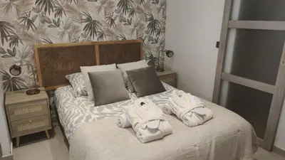 a bedroom with a bed with towels on it at Entre Sorgue et sens in LʼIsle-sur-la-Sorgue