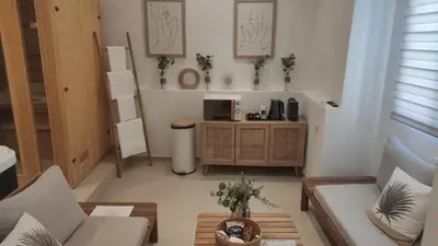 a living room with a couch and a coffee table at Entre Sorgue et sens in LʼIsle-sur-la-Sorgue