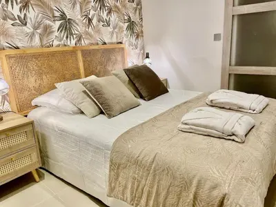 a bedroom with a bed with two pillows on it at Entre Sorgue et sens in LʼIsle-sur-la-Sorgue