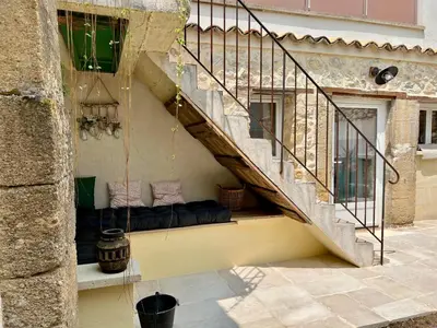 a couch sitting under a staircase in a building at L'Ecrin de Mérindol in Mérindol