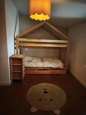 a bedroom with a bunk bed and a rug at La dominique in Villes-sur-Auzon
