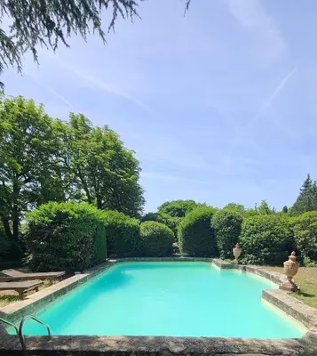 a large blue swimming pool in a garden at Havre de Paix en Provence in Aix-en-Provence