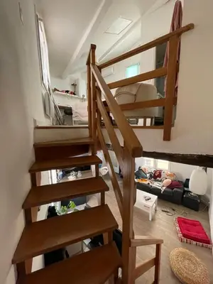 a living room with stairs leading to a loft at inactive in Aix-en-Provence