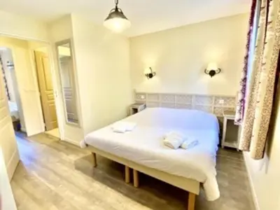 a bedroom with a white bed with two pillows on it at Maison en Provence avec Piscine et Climatisation - FR-1-658-36 in Mallemort