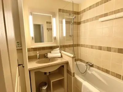 a bathroom with a sink and a mirror and a tub at Maison en Provence avec Piscine et Climatisation - FR-1-658-36 in Mallemort