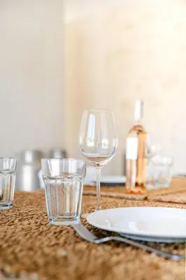 a table with glasses and a plate on a table at La Bergerie Ferme du Montaiguet in Aix-en-Provence