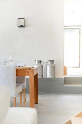 a dining room with a wooden table and a window at La Bergerie Ferme du Montaiguet in Aix-en-Provence