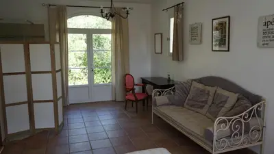 a living room with a couch and a table at Bastide Clementine in LʼIsle-sur-la-Sorgue