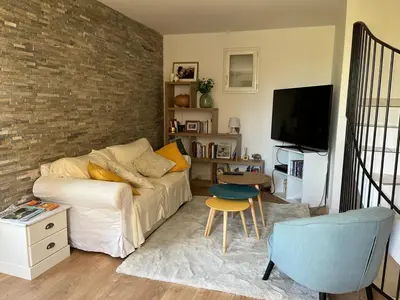 a living room with a couch and a tv at Maison village provençal in Éguilles