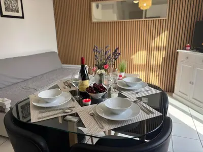 a table with a bottle of wine and glasses on it at Douceur de vivre en Provence in Saint-Saturnin-lès-Avignon