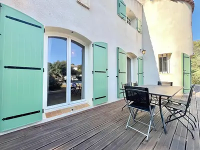 a patio with a table and chairs on a deck at Casa Corniou - Calme, Village Provençal, 3 chambres, 2 SDB, 8 personnes in Cornillon-Confoux