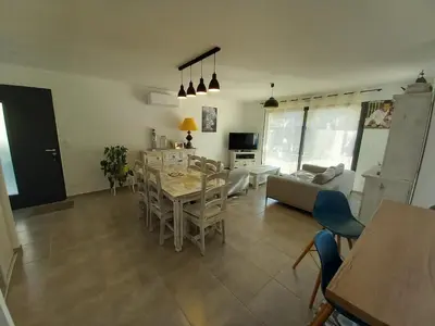 a kitchen and living room with a table and chairs at Maison en Provence 7 personnes avec piscine in Carpentras