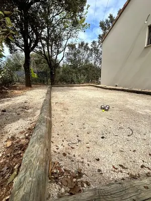an empty yard with a fence and trees and a building at Maison en Provence 7 personnes avec piscine in Carpentras