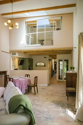 a living room with a table and a couch at Artist's Villa With Pool Near Aix-En-Provence in Alleins