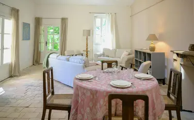 a living room with a table with a pink table cloth at Artist's Villa With Pool Near Aix-En-Provence in Alleins