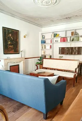 a living room with a blue couch and a fireplace at Artist's Villa With Pool Near Aix-En-Provence in Alleins