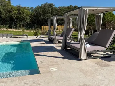 a gazebo and chairs next to a swimming pool at Keur Bouyo - Provençal Luxury Retreat in Saint-Saturnin-les-Apt