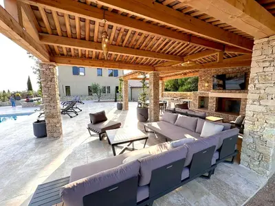 a pavilion with couches and chairs on a patio at Keur Bouyo - Provençal Luxury Retreat in Saint-Saturnin-les-Apt