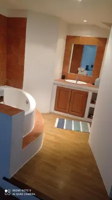 a bathroom with a tub and a sink at Chez Rachel in La Bastide-des-Jourdans