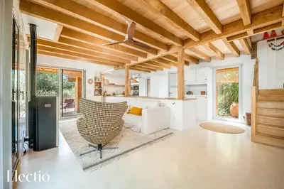 a kitchen and living room with wooden ceilings at Cabane dIsmou Pool & Wood Design in La Roque-dʼAnthéron