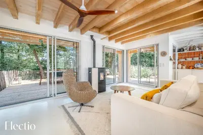 a living room with a couch and a table at Cabane dIsmou Pool & Wood Design in La Roque-dʼAnthéron