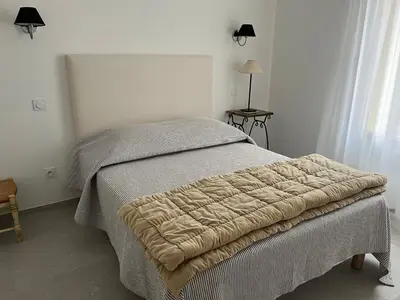 a bedroom with a bed with a blanket on it at Maison dans un hameau avec piscine in Gordes