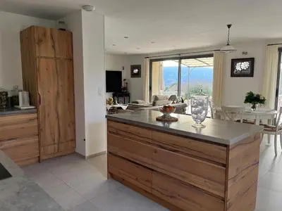 a kitchen with a large island in the middle at Maison dans un hameau avec piscine in Gordes