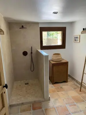 a bathroom with a shower with a sink and a window at The Farmhouse in the shade of the plane trees in Cavaillon