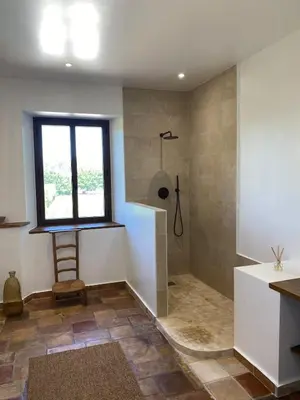 a bathroom with a shower and a window at The Farmhouse in the shade of the plane trees in Cavaillon
