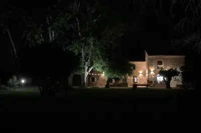 a house lit up at night with lights at The Farmhouse in the shade of the plane trees in Cavaillon