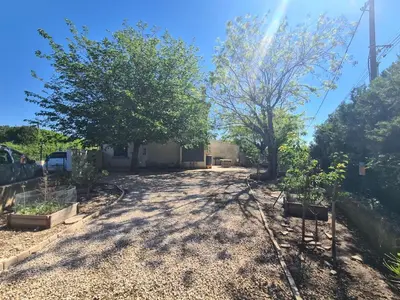 a driveway with two trees in a yard at Villa avec piscine en Provence in Pernes-les-Fontaines