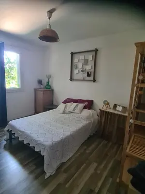 a bedroom with a white bed and a wooden floor at Villa avec piscine en Provence in Pernes-les-Fontaines
