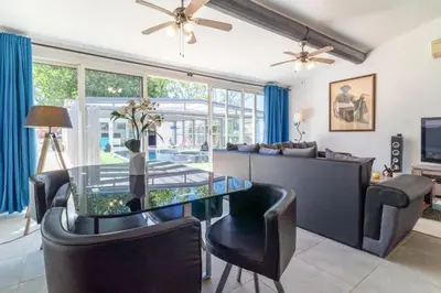 a living room with a glass table and a couch at Le logis de la castagne in Caumont-sur-Durance
