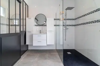 a bathroom with a shower and a sink and a mirror at Le logis de la castagne in Caumont-sur-Durance