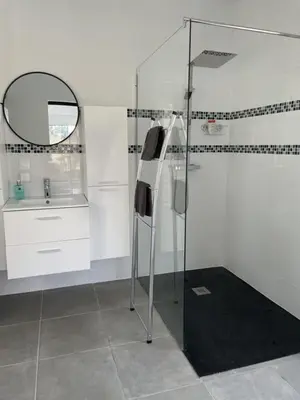 a bathroom with a glass shower and a sink at Le logis de la castagne in Caumont-sur-Durance