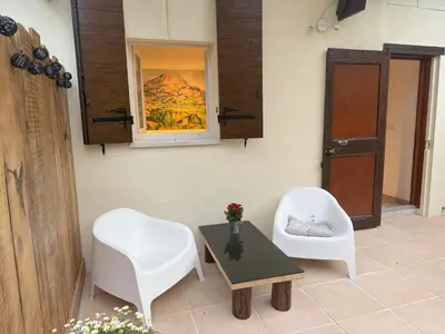 a room with two chairs and a table and a mirror at Studio terrasse in Aix-en-Provence