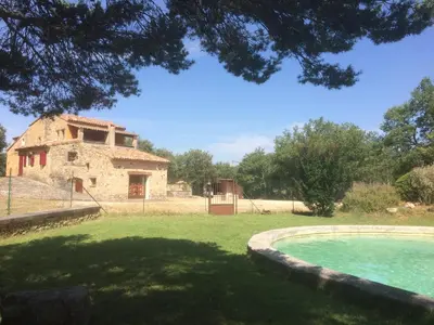 an old stone house and a swimming pool in a yard at Maison typique provençale au calme absolu dans le triangle d or a Bonnieux in Bonnieux