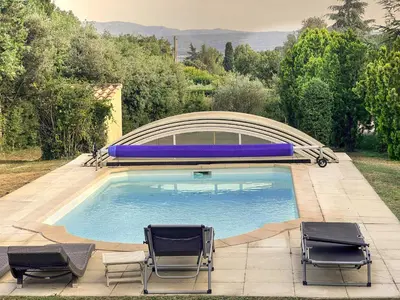 a swimming pool with two lawn chairs and two lawn chairs at La maison de l'olivier in Saint-Saturnin-les-Apt